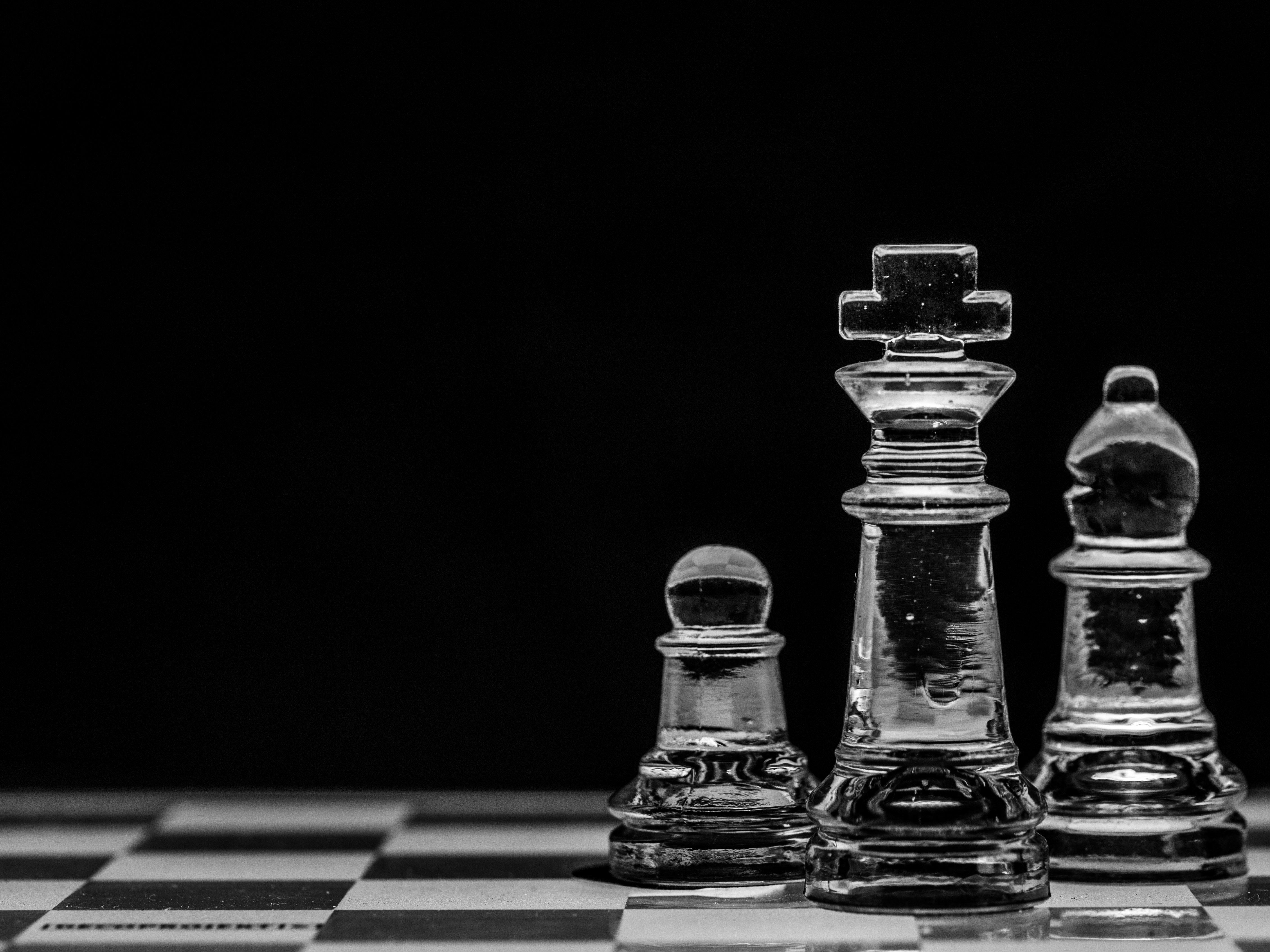 Strategy Icon, three pieces of chess on a chessboard